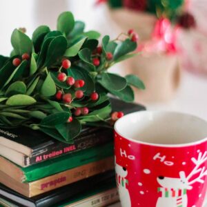flowers on top of stacked books and mug