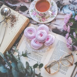 floral ceramic cup and saucer above open book